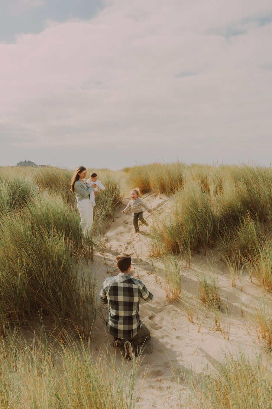 Familie wandelt door duinen bij de kust